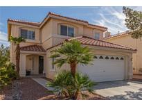Two-story home with desert landscaping, a red tile roof, and an attached two-car garage at 10103 Flagstaff Butte Ave, Las Vegas, NV 89148