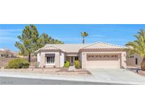 Charming single-story home featuring desert landscaping, tile roof, and an attached two-car garage at 10920 Black Ledge Ave, Las Vegas, NV 89134