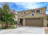 Inviting two-story home featuring a well-maintained lawn, desert landscaping, and attached two-car garage at 1131 Sax Fifth Ave, Henderson, NV 89052