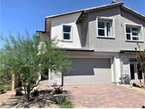 Charming two-story home with a two-car garage, brick driveway, and desert landscaping in a sunny setting at 116 Antler Square Ln, Henderson, NV 89011