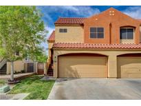 Two-story home showcasing a two-car garage, red tile roof, and well-maintained lawn with a tree at 1660 Cloister Ave, Henderson, NV 89014