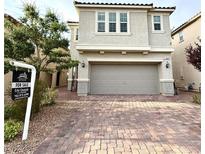 Charming two-story home with a two-car garage and a beautifully paved driveway at 2922 Tranquil Brook Ave, Henderson, NV 89044