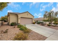 Charming single story home featuring a tile roof, desert landscaping, and an attached two car garage at 2969 Sumter Valley Cir, Henderson, NV 89052