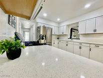 Bright kitchen features white cabinets, stainless steel appliances, and a spacious countertop at 4324 El Conlon Ave, Las Vegas, NV 89102