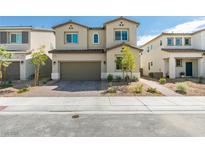 Two story home featuring a two car garage, desert landscaping and neutral colored stucco at 4642 Chirping St, North Las Vegas, NV 89031