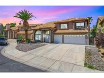 Charming two-story home features a tile roof, desert landscaping, and a spacious driveway at 5 Red Fawn Ct, Henderson, NV 89074