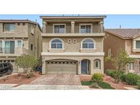Charming three-story home features a balcony, arched windows, neutral stucco, and a two car garage at 5340 Kennedy Hill Ave, Las Vegas, NV 89139