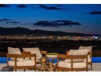 Stunning Las Vegas city view from the outdoor seating area at night at 667 Palisade Rim Dr, Henderson, NV 89012