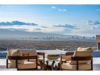Expansive city views from this gorgeous patio with comfortable seating and clear skies at 667 Palisade Rim Dr, Henderson, NV 89012