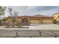 Charming single-story home featuring a three-car garage and well-maintained front yard in a suburban setting at 7568 Shadow Estates Way, Las Vegas, NV 89113