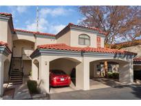 Inviting condo with a red tile roof and convenient covered parking, perfect for comfortable living at 8455 W Sahara Ave # 287, Las Vegas, NV 89117