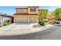 Two-story home featuring an attached three car garage, desert landscaping and a red tile roof at 9413 Artesian Oak Ct, Las Vegas, NV 89149
