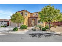 Charming two-story home with desert landscaping, stone accents, arched entry, and a two car garage at 9413 Artesian Oak Ct, Las Vegas, NV 89149
