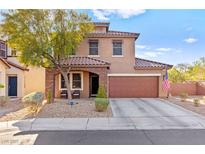 Charming two-story home featuring a well-manicured front yard and inviting curb appeal on a sunny day at 10113 Fluffy Fox Ct, Las Vegas, NV 89178