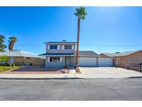 Charming two-story home with a well-maintained front yard, long driveway, and a grand palm tree in the front at 125 Sam Jonas Dr, Las Vegas, NV 89145