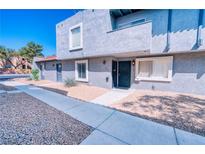 Charming two-story condo features well-maintained landscaping, stucco exterior, and a concrete pathway at 1326 N Jones Blvd, Las Vegas, NV 89108
