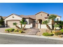 Charming single-story home featuring desert landscaping, a brick-paved driveway, and gated courtyard entry at 2373 Black River Falls Dr, Henderson, NV 89044