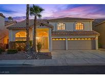 Charming two-story home boasting a tile roof, three-car garage, and professionally landscaped front yard at 2445 Antler Point Dr, Henderson, NV 89074