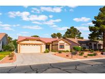 Charming one-story home featuring a well-maintained lawn, two-car garage, and desert landscaping at 5029 Pacific Grove Dr, Las Vegas, NV 89130