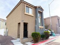 Inviting two-story home featuring a neutral stucco facade, complemented by well-kept landscaping at 5271 Aurora Beam Ave, Las Vegas, NV 89122