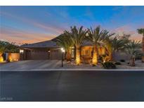 Charming home exterior at dusk featuring a three-car garage and lush palm tree landscaping at 6012 Chessington Ave, Las Vegas, NV 89131