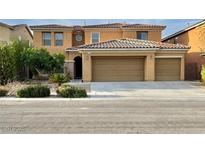 Inviting two-story home with a three car garage, complemented by lush landscaping at 7216 Campolina Ct, Las Vegas, NV 89113