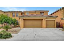 Spacious home featuring a three-car garage with a beautiful terracotta-colored tile roof at 7216 Campolina Ct, Las Vegas, NV 89113