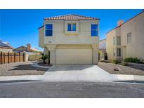 Two-story home features a two-car garage and low maintenance landscaping at 8329 Telescope Peak Ct, Las Vegas, NV 89145