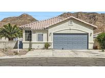 Inviting single-story home with a two-car garage and desert landscaping at 1252 N Sloan Ln, Las Vegas, NV 89110