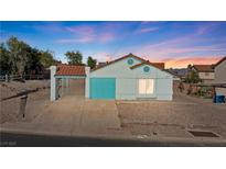 Charming single-story home featuring a tile roof, covered parking, and desert landscaping at 1775 Esteban Ave, Laughlin, NV 89029