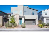 Modern two-story home features a gray color scheme, stone accents, and a two-car garage at 2510 Verdello St, Henderson, NV 89044