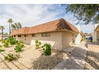View of the home's exterior with low maintenance desert landscaping and a brick chimney on a sunny day at 2645 Heritage Ct, Las Vegas, NV 89121