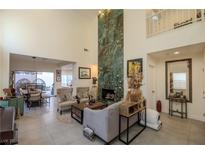 Bright and airy living room featuring a striking fireplace and plenty of natural light at 2649 Golden Sands Dr, Las Vegas, NV 89128