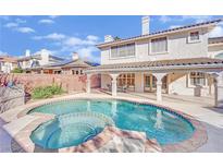Inviting backyard pool and spa with covered patio and a lush landscape, perfect for outdoor relaxation and entertaining at 3755 Broadmead St, Las Vegas, NV 89147