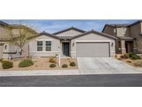Charming single-story home featuring a two-car garage and low-maintenance landscaping at 412 Horsetail Falls St, Indian Springs, NV 89018