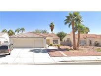 Charming single-story home with a terra cotta roof, desert landscaping, and two-car garage at 4908 Wind Break Ln, North Las Vegas, NV 89031