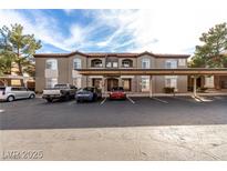 Condominium building with covered parking spots and appealing tan exterior paint and trim at 9000 Las Vegas Blvd # 2243, Las Vegas, NV 89123
