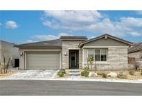 Charming single-story home featuring a gray stone facade, two car garage, and well-maintained landscaping at 11137 Black Fire Opal Dr, Las Vegas, NV 89138
