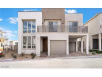 Charming two-story home showcasing modern design with a balcony and attached garage at 1790 Sparrow Song Ct, Las Vegas, NV 89138