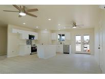 Bright open-concept kitchen featuring stainless steel appliances and a central island with quartz countertops at 220 N David St, Pahrump, NV 89060