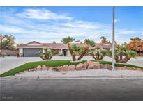 Charming single-story home featuring a well-manicured lawn, mature landscaping, and a three-car garage at 3334 W Mardon Ave, Las Vegas, NV 89139