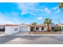 Charming single-story home featuring a two car garage and desert landscaping with mature palms at 3661 Margarita Way, Las Vegas, NV 89103