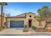 Charming single-story home with desert landscaping, a two car garage, and a tile roof at 519 Via Garofano Ave, Henderson, NV 89011