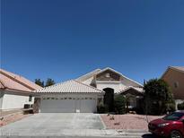 Charming single-story home featuring a three-car garage and desert landscaping at 5554 Chicory Falls Ct, Las Vegas, NV 89148