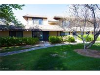 Well-manicured home featuring lush green lawn and mature landscaping at 6227 Meadowgrass Ln, Las Vegas, NV 89103