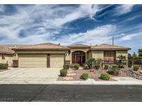 Charming single-story home with a two-car garage, desert landscaping, and an inviting entryway gate at 8698 Waterford Bend St, Las Vegas, NV 89123