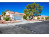 Charming single-story home featuring a well-maintained front yard, a two-car garage, and a tile roof at 8813 Sundial Dr, Las Vegas, NV 89134