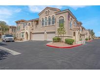 Beautiful stucco two-story home showcasing a two-car garage, manicured landscaping, and ample parking at 10550 W Alexander Rd # 2064, Las Vegas, NV 89129
