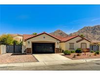 Charming single-story home with a red tile roof, desert landscaping and mountain views at 1110 Azure Heights Pl, Las Vegas, NV 89110