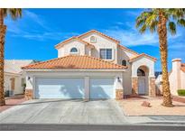 Inviting two-story home featuring a terracotta roof, a two car garage and desert landscaping at 1142 Teal Point Dr, Henderson, NV 89074